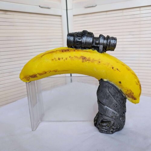 Picture of a foam gun made out of a banana with handle and scope.